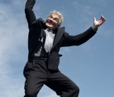 image of retiring man jumping up in the air in glee
