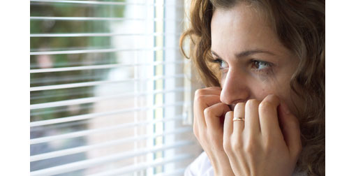 lady looking out window nervously