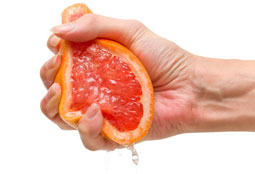 orange being squeezed